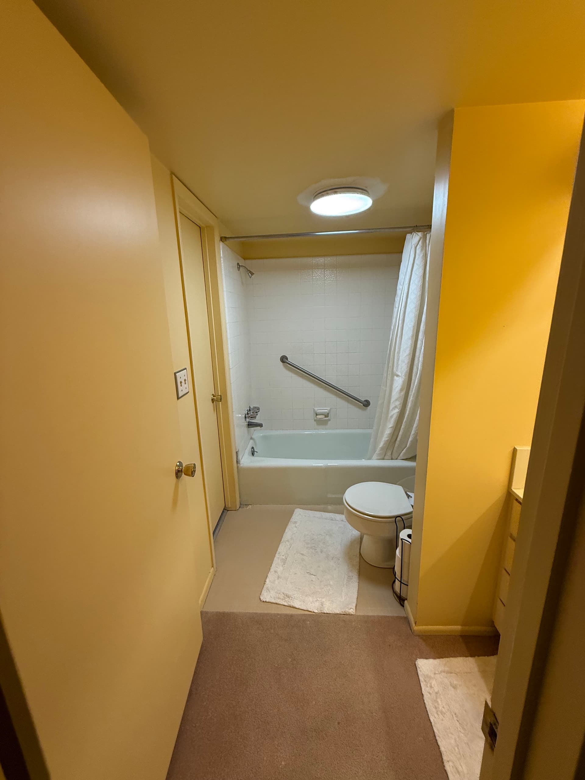 From Dated Yellow Walls to a Clean, Custom Bathroom Remodel image