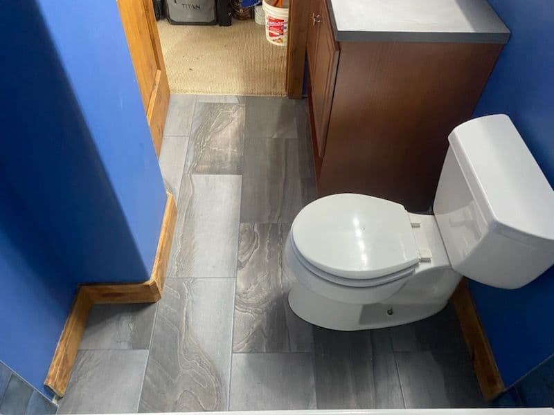 Glossy Blue Tile Masterpiece and Marble Accented Shower Install